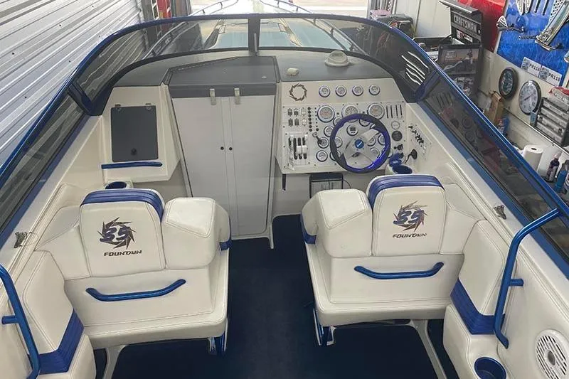 Slide: The Image of Interior of a 2001 Fountain 35 Lightning boat with white and blue seating. - 13
