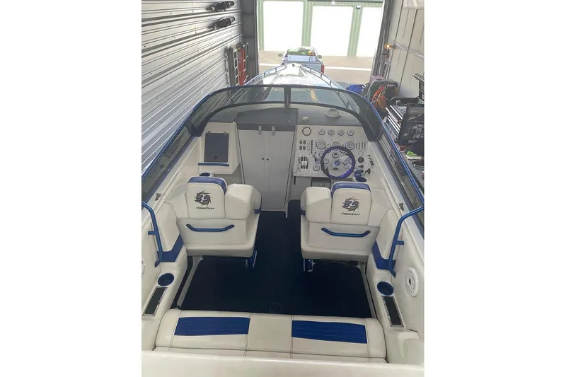 Slide: The Image of 2001 Fountain 35 Lightning boat interior with blue and white seating and control panel. - 15