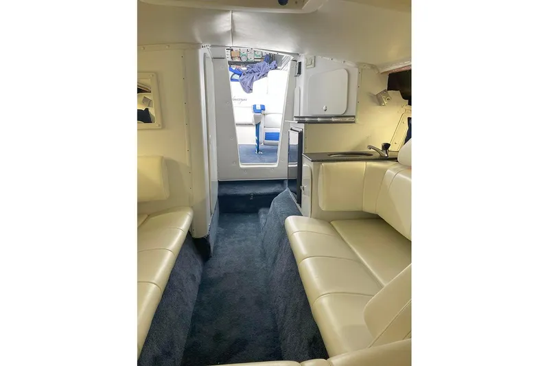 Slide: The Image of Interior of 2001 Fountain 35 Lightning boat with beige seating and compact kitchenette. - 20