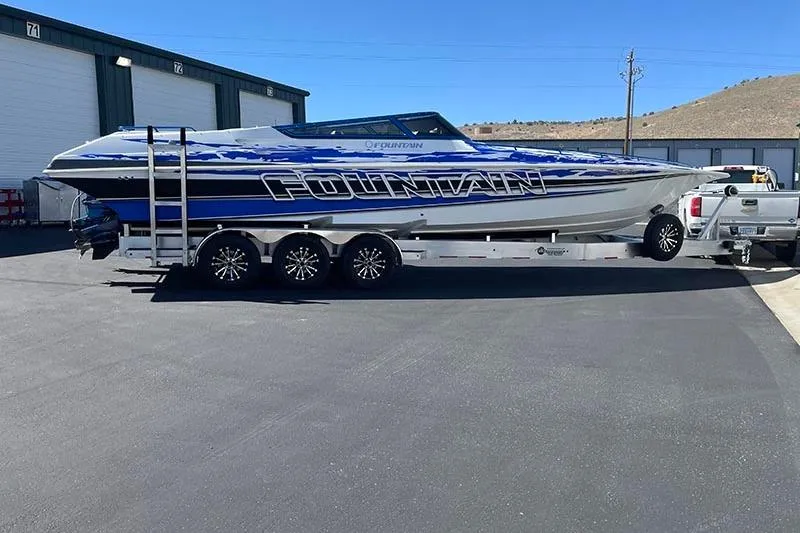 Slide: The Image of 2001 Fountain 35 Lightning boat on trailer, parked outdoors near storage units. - 3