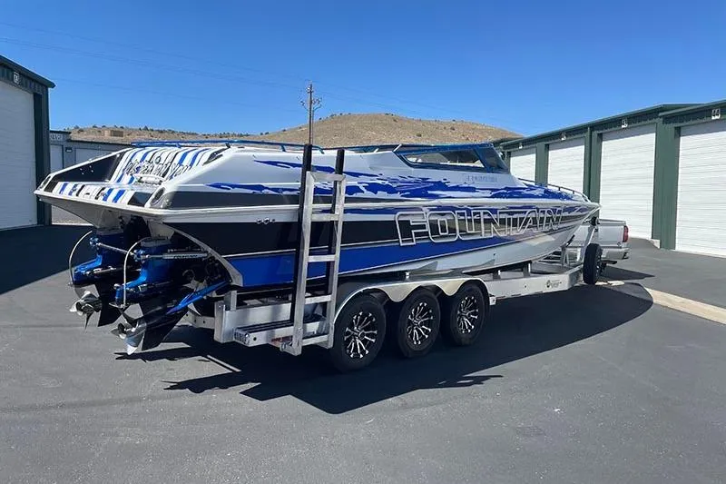 Slide: The Image of 2001 Fountain 35 Lightning speedboat on trailer, parked near storage units. - 7