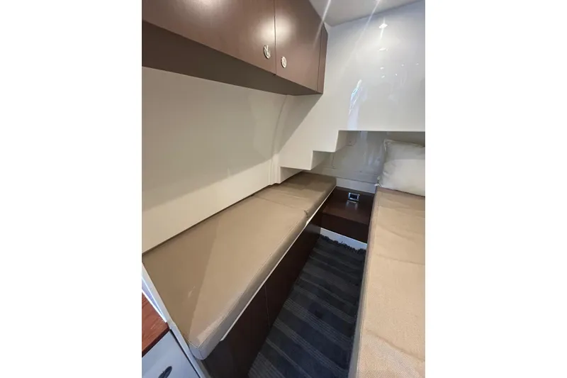 Slide: The Image of 2016 Sea Ray L650 cabin interior with twin beds and modern design. - 10