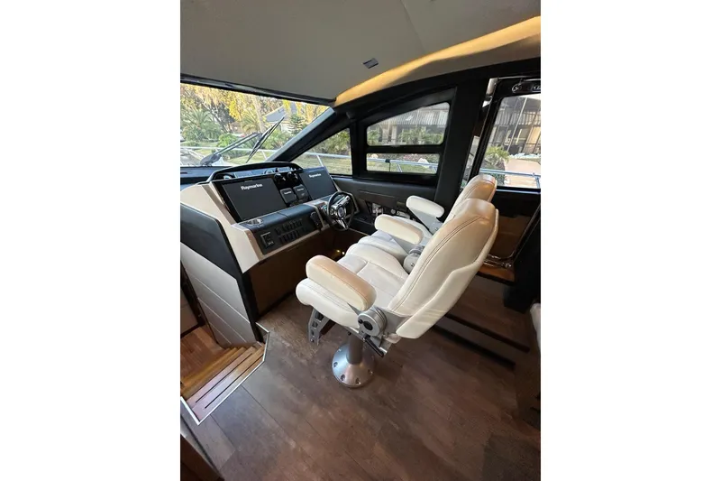 Slide: The Image of Interior helm of 2016 Sea Ray L650 yacht with modern controls and seating. - 12