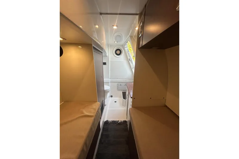 Slide: The Image of Interior of 2016 Sea Ray L650 yacht cabin with twin beds and modern design. - 14