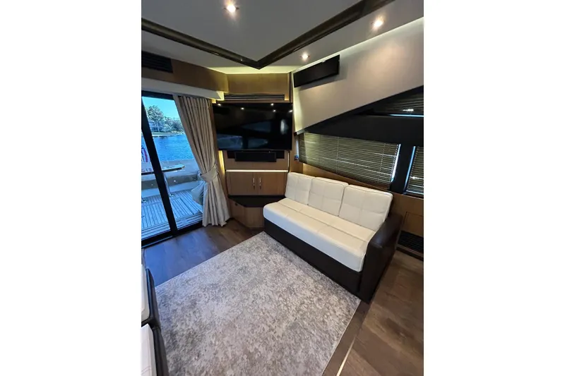Slide: The Image of Luxurious interior of 2016 Sea Ray L650 yacht with modern sofa and large TV. - 16