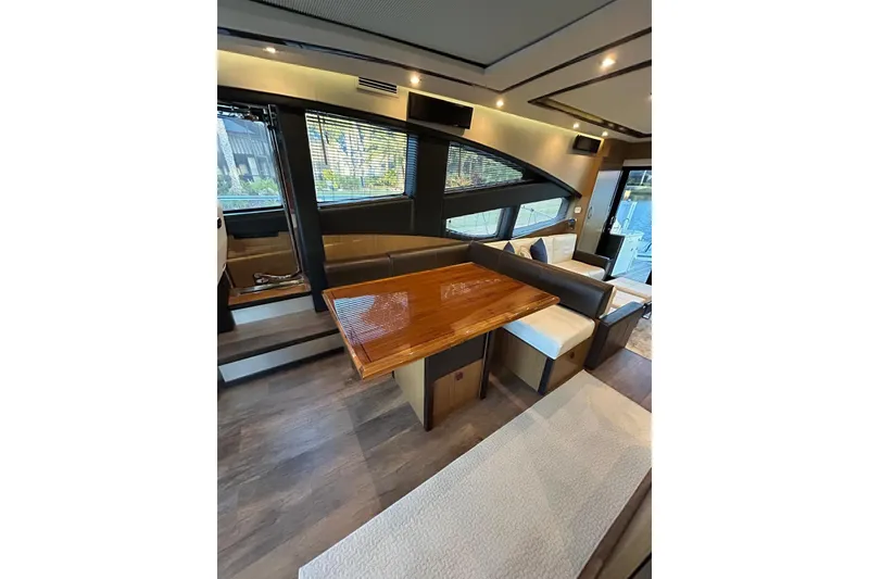 Slide: The Image of Luxurious interior of 2016 Sea Ray L650 yacht with elegant seating and wooden table. - 21