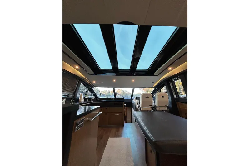 Slide: The Image of Luxurious interior of 2016 Sea Ray L650 yacht with panoramic windows and modern furnishings. - 22