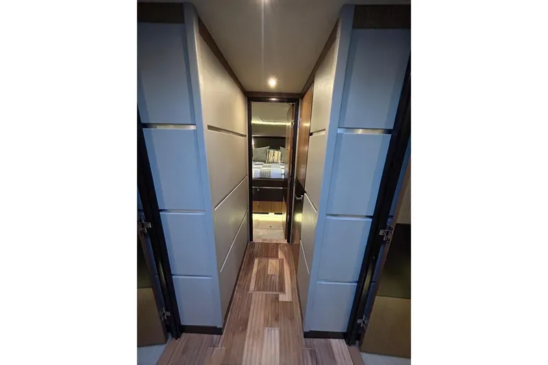 Slide: The Image of Luxurious interior hallway of 2016 Sea Ray L650 yacht, featuring modern design and ambient lighting. - 25