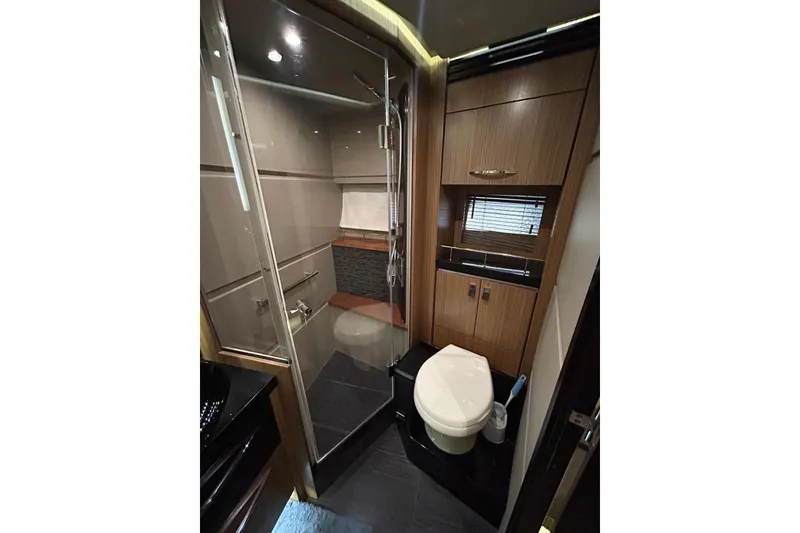 Slide: The Image of Luxurious bathroom in 2016 Sea Ray L650 yacht with modern fixtures and wood accents. - 27