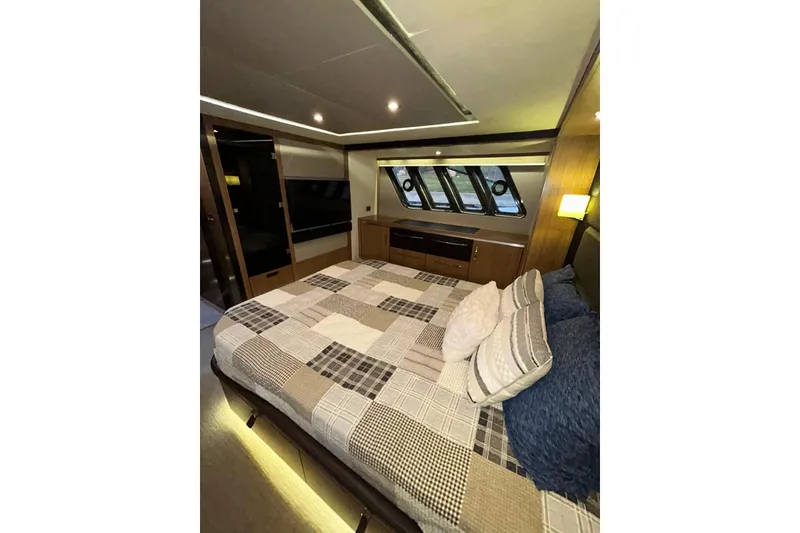 Slide: The Image of Luxurious 2016 Sea Ray L650 yacht bedroom with modern decor and large windows. - 35