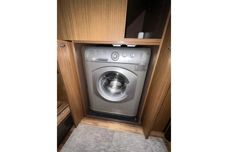 Slide: The Image of Washing machine inside 2016 Sea Ray L650 yacht's wooden cabinet. - 36