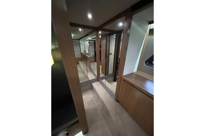 Slide: The Image of Luxurious interior of 2016 Sea Ray L650 yacht with wood finishes and mirrored closet. - 39