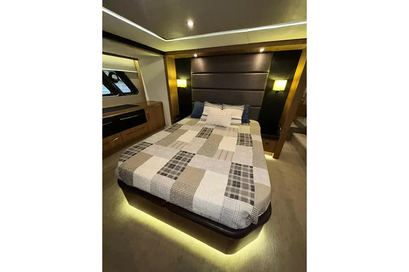 Slide: The Image of Luxurious 2016 Sea Ray L650 yacht bedroom with modern decor and ambient lighting. - 40