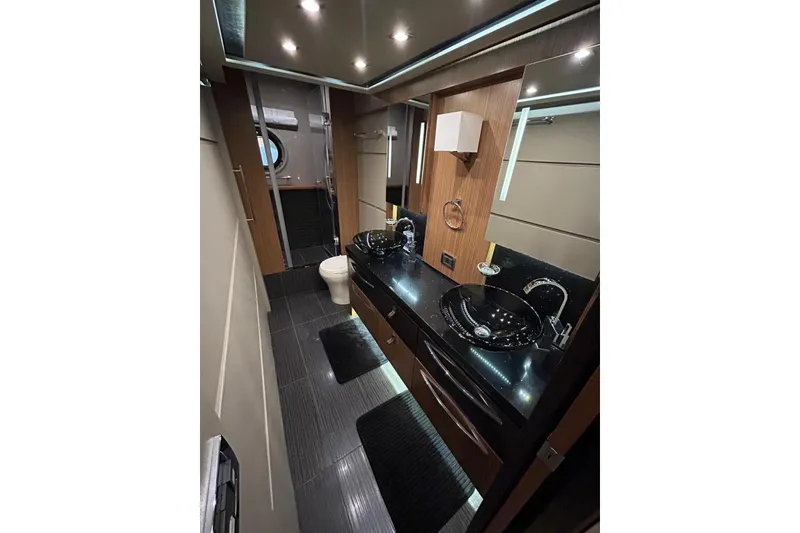 Slide: The Image of Luxurious bathroom in 2016 Sea Ray L650 yacht with dual sinks and modern fixtures. - 41
