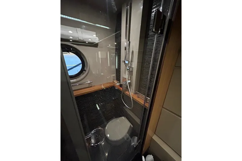 Slide: The Image of Luxurious bathroom in 2016 Sea Ray L650 yacht with modern shower and porthole window. - 42