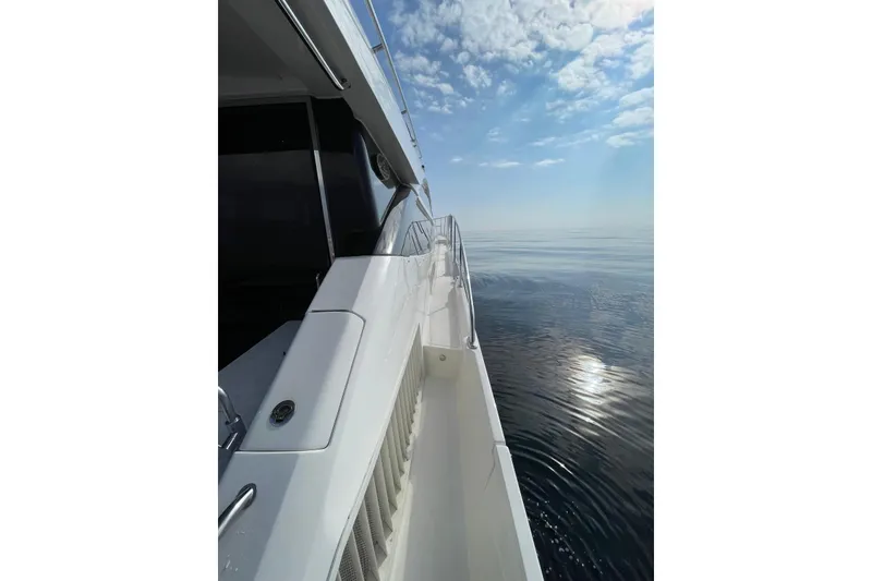 Slide: The Image of 2016 Sea Ray L650 yacht cruising on calm ocean under a clear blue sky. - 50