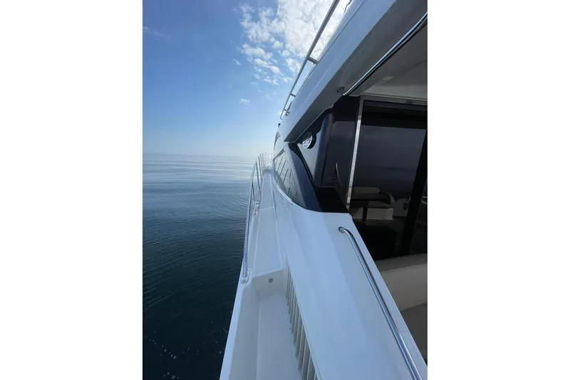 Slide: The Image of 2016 Sea Ray L650 yacht cruising on calm ocean waters under a clear blue sky. - 51