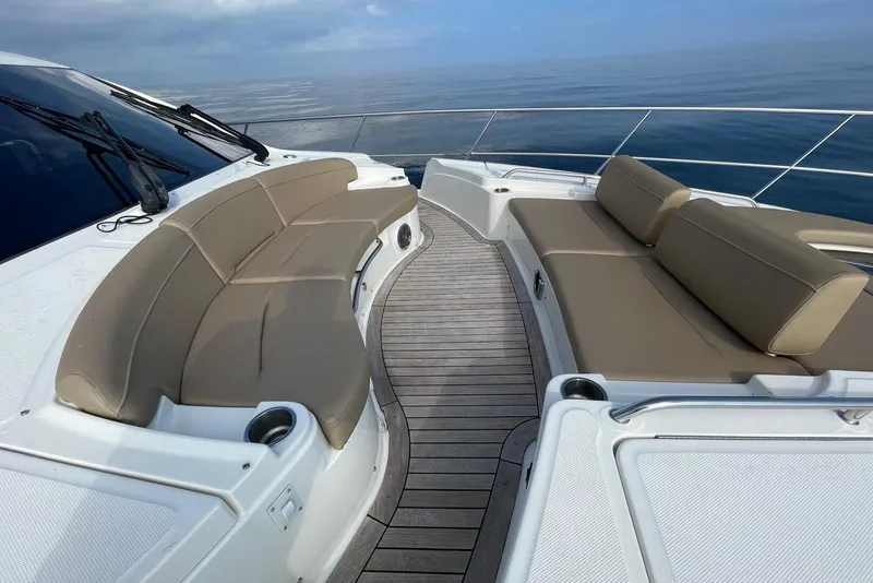 Slide: The Image of Luxurious seating area on 2016 Sea Ray L650 yacht, overlooking calm ocean waters. - 55