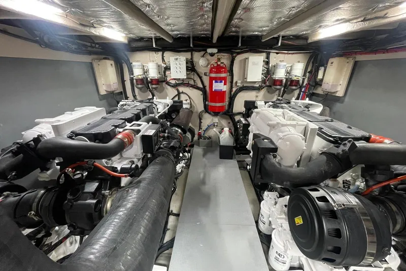 Slide: The Image of Engine room of 2016 Sea Ray L650 yacht, featuring dual engines and fire safety equipment. - 62