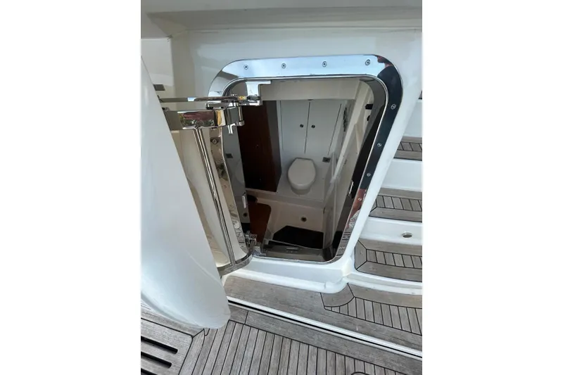 Slide: The Image of 2016 Sea Ray L650 yacht bathroom entrance with sleek chrome door and wooden flooring. - 8