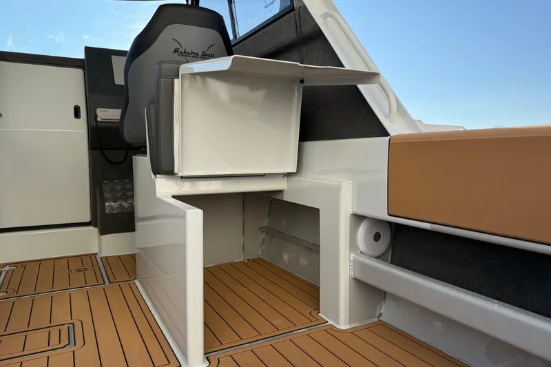 Slide: The Image of 2026 Makaira Gen3 26 Outboard interior with modern seating and wood-style flooring. - 10