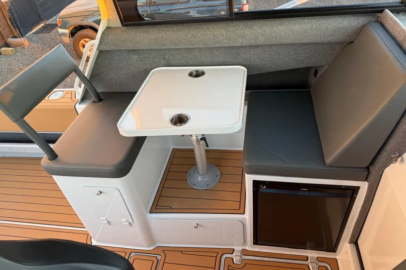 Slide: The Image of Interior of 2026 Makaira Gen3 26 Outboard boat with seating and table. - 15