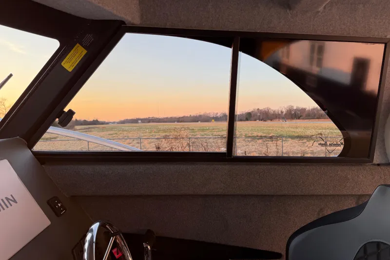 Slide: The Image of Interior view of 2026 Makaira Gen3 26 Outboard, showcasing window and scenic landscape. - 26