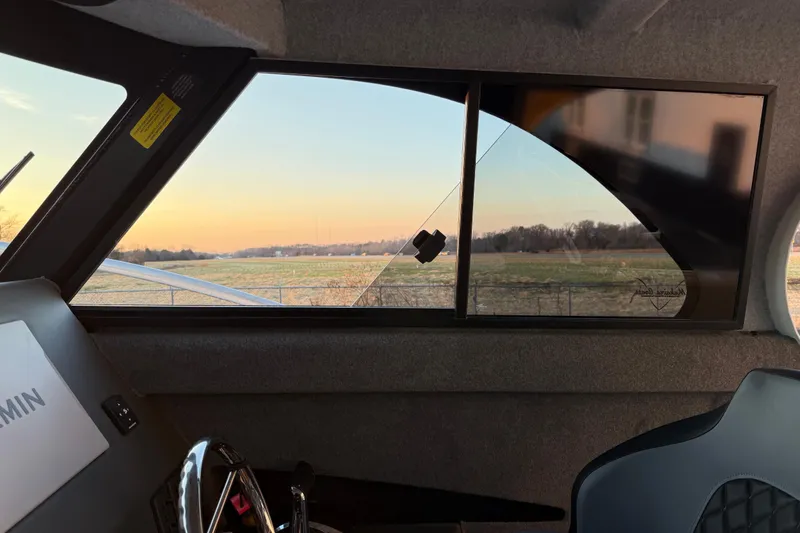 Slide: The Image of Interior view of 2026 Makaira Gen3 26 Outboard boat with scenic landscape through window. - 27