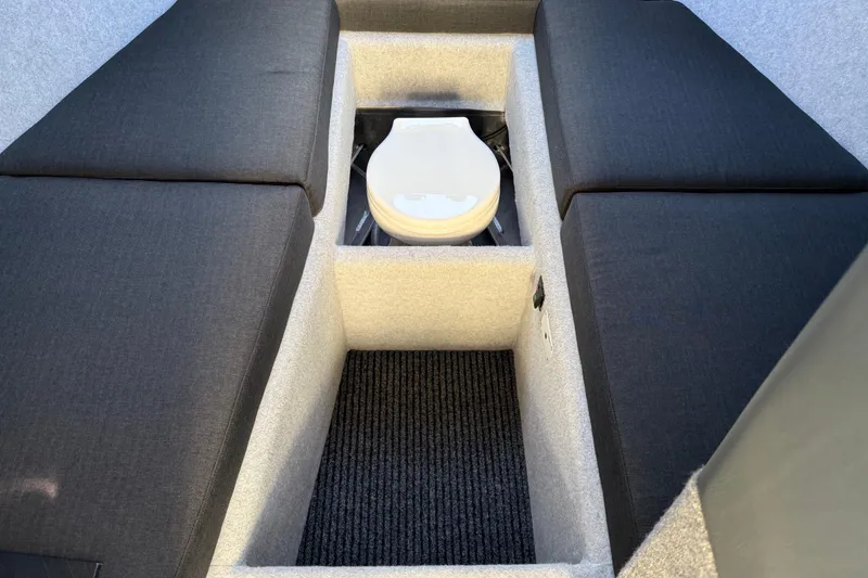 Slide: The Image of 2026 Makaira Gen3 26 Outboard interior with cushioned seating and built-in toilet. - 29