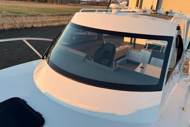 Slide: The Image of 2026 Makaira Gen3 26 Outboard boat with sleek windshield and modern interior design. - 40