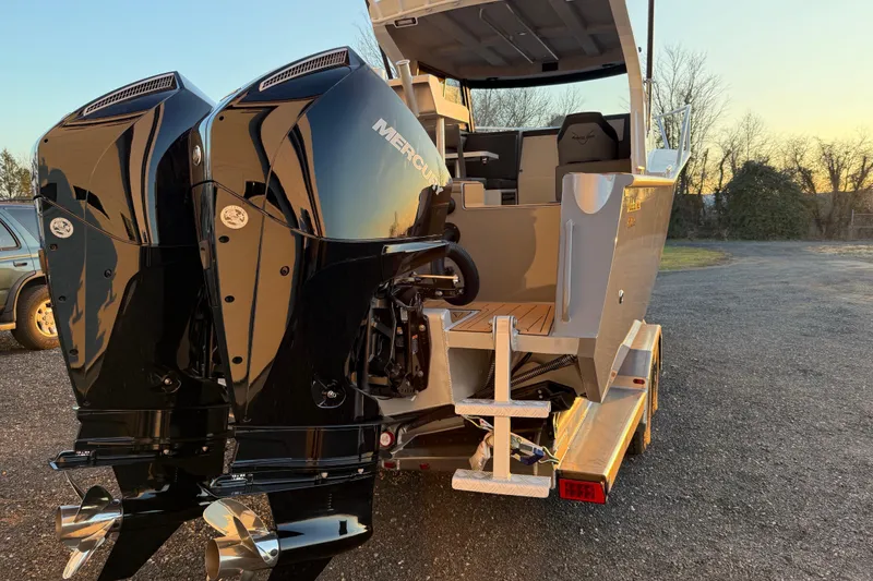 Slide: The Image of 2026 Makaira Gen3 26 Outboard boat with dual Mercury engines at sunset. - 47