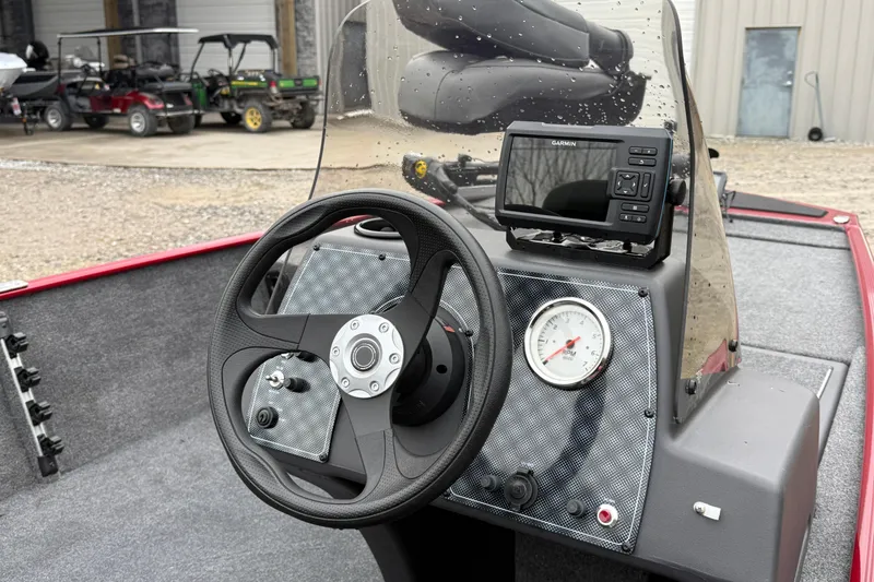 Slide: The Image of 2025 Tracker Bass Tracker Classic XL dashboard with steering wheel and Garmin GPS. - 6