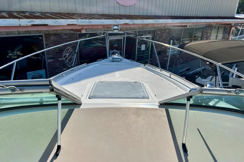 Slide: The Image of Front deck view of a 2000 Larson 290 CABRIO boat at a marina. - 11