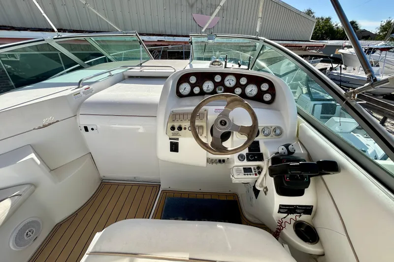 Slide: The Image of 2000 Larson 290 Cabrio boat cockpit with steering wheel and instrument panel. - 13