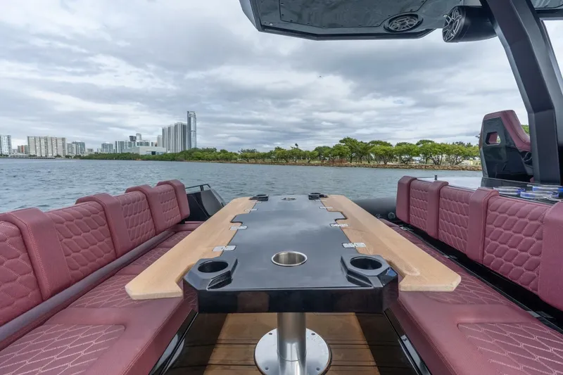 Slide: The Image of Luxurious 2023 Skipper-BSK 42 boat interior with red seating and scenic waterfront view. - 10