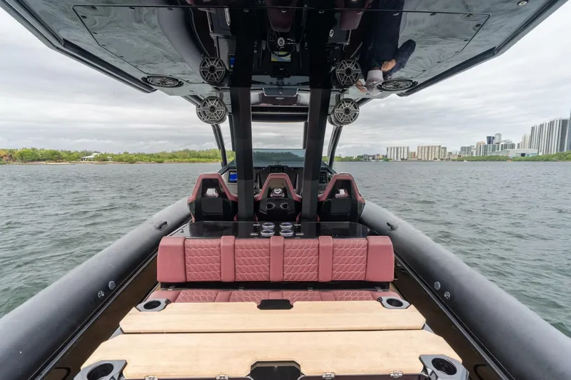 Slide: The Image of Luxury Skipper-BSK 42 boat interior, 2023 model, on water with cityscape background. - 12