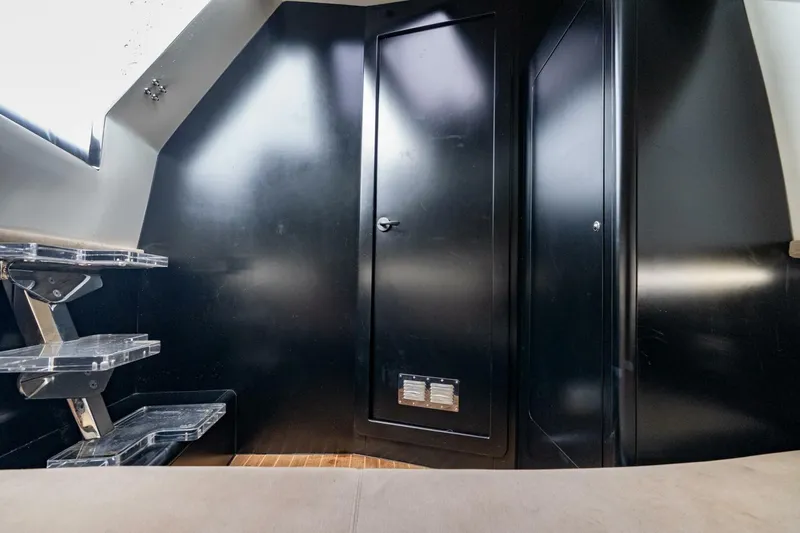 Slide: The Image of Interior of 2023 Skipper-BSK 42 boat with sleek black walls and modern design. - 15