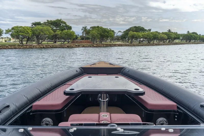 Slide: The Image of Skipper-BSK 42 boat interior with seating and table, 2023 model, on a scenic waterway. - 21