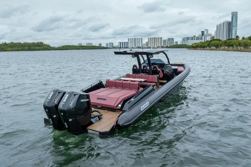 Slide: The Image of Skipper-BSK 42 boat, 2023 model, on water with city skyline in background. - 5