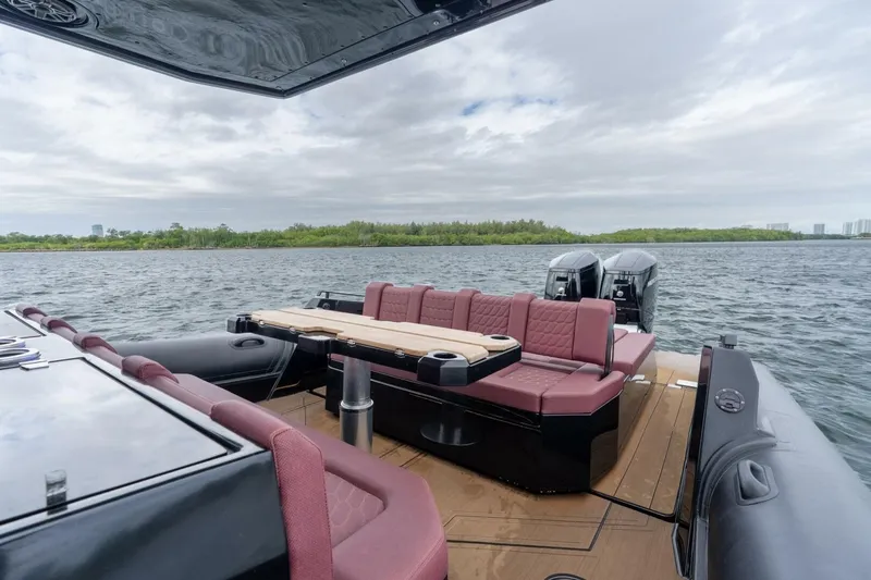 Slide: The Image of Luxurious 2023 Skipper-BSK 42 boat with plush seating and dual engines on open water. - 9