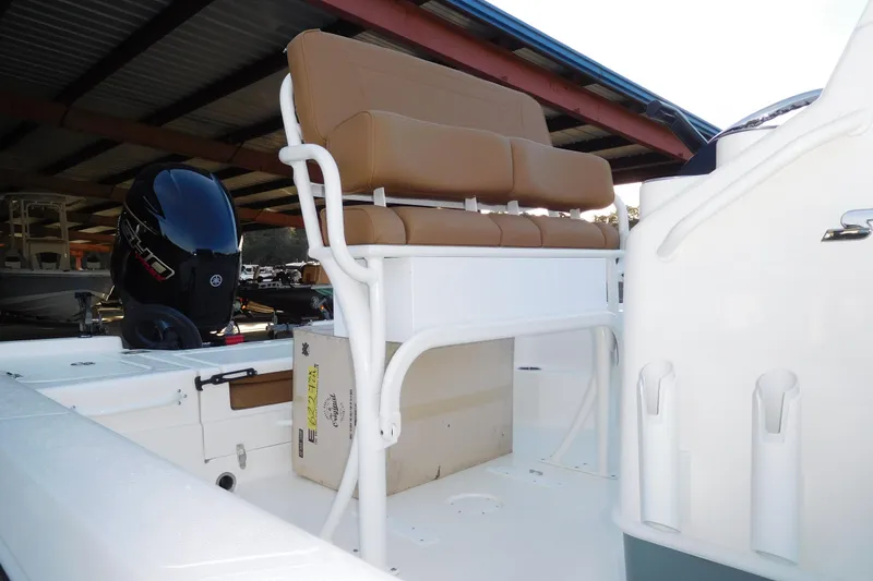 Slide: The Image of 2026 Skeeter SX221 boat interior with seating and outboard motor. - 3