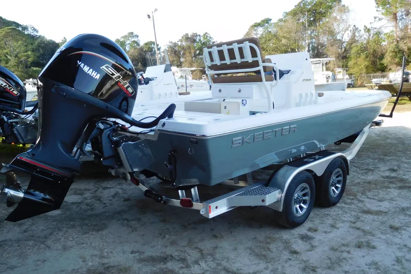 Slide: The Image of 2026 Skeeter SX221 boat with Yamaha engine on a trailer, parked outdoors. - 4