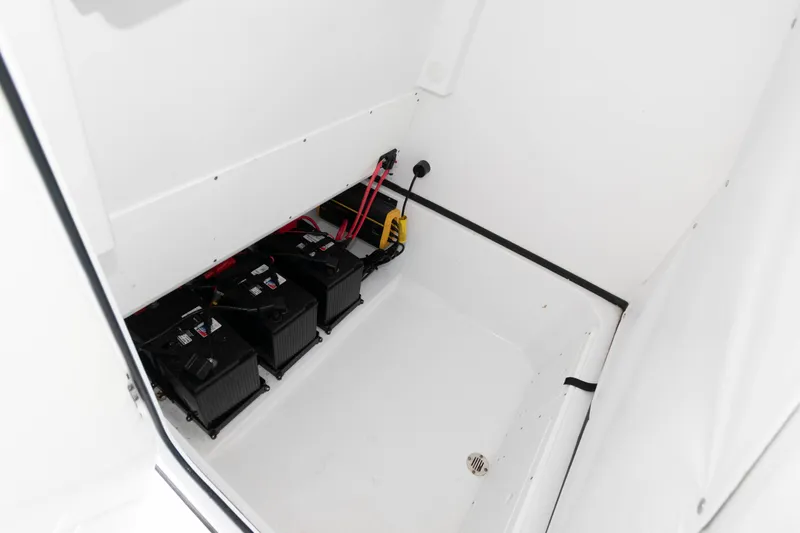 Slide: The Image of 2024 Sportsman Open 252 Center Console battery compartment with three batteries and wiring. - 15