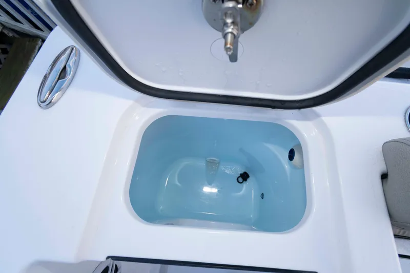 Slide: The Image of 2024 Sportsman Open 252 Center Console livewell with open lid and water inside. - 16