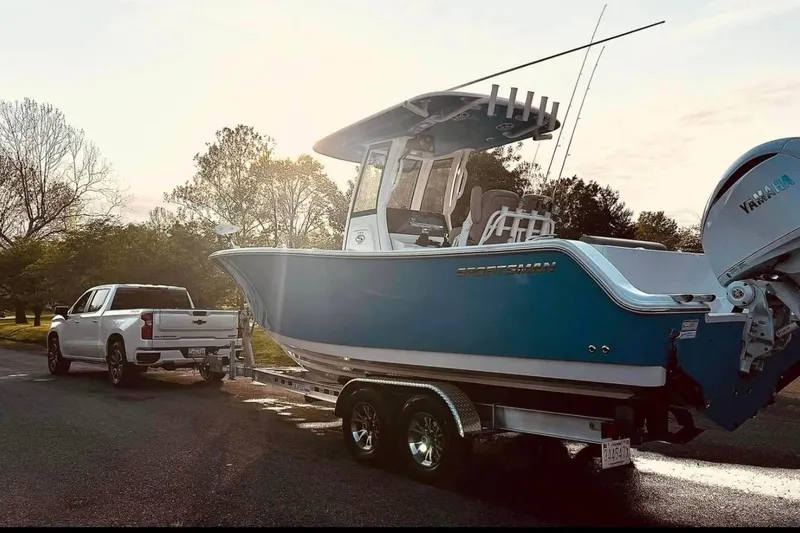 Slide: The Image of 2024 Sportsman Open 252 Center Console boat on trailer, parked outdoors. - 3