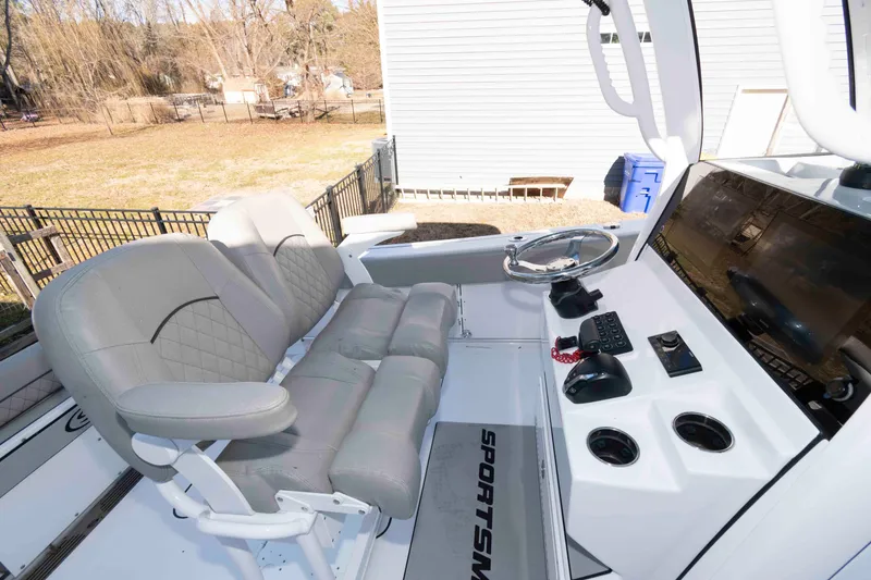 Slide: The Image of 2024 Sportsman Open 252 Center Console boat interior with helm and seating. - 6