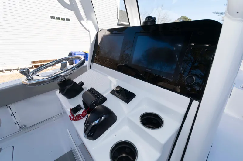 Slide: The Image of 2024 Sportsman Open 252 Center Console dashboard with steering wheel and electronic displays. - 7