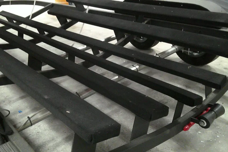 Slide: The Image of Trailer frame for 2025 Tahoe T21 boat, featuring black padded supports. - 14