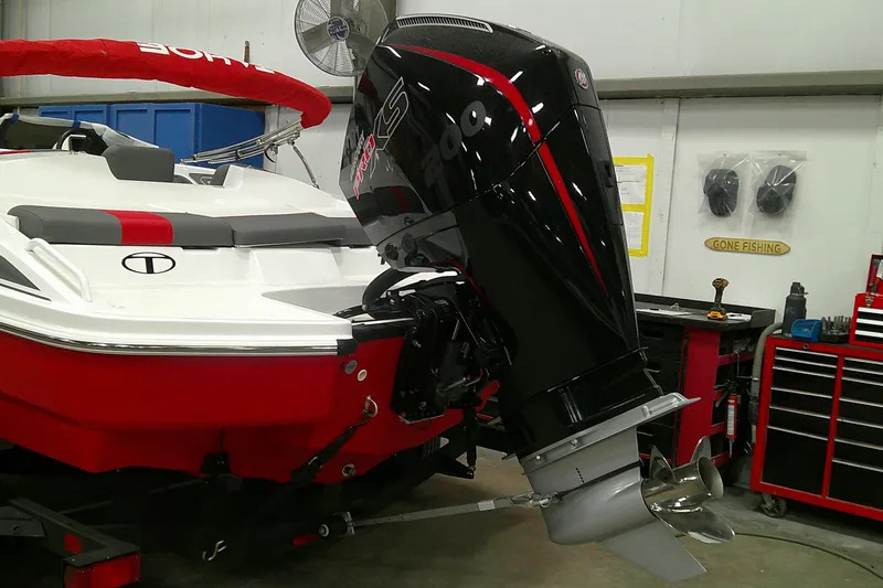 Slide: The Image of 2025 Tahoe T21 boat with powerful outboard motor in a workshop setting. - 3