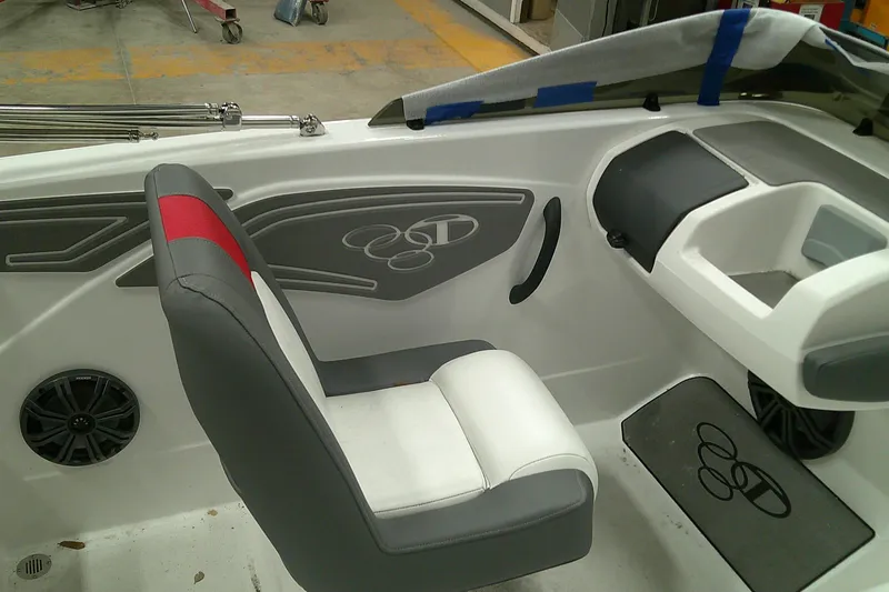 Slide: The Image of Interior of 2025 Tahoe T21 boat with gray and red seating, modern dashboard. - 6